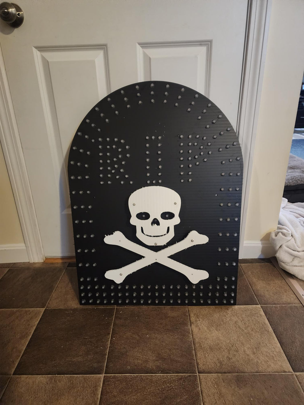 Tombstone with back lit skull and bones